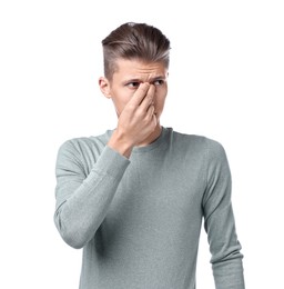 Young man suffering from sinusitis on white background