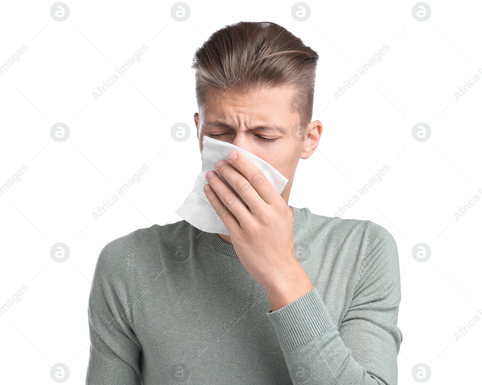 Photo of Young man with tissue suffering from sinusitis on white background