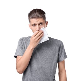 Photo of Young man with tissue suffering from sinusitis on white background