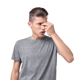 Young man suffering from sinusitis on white background