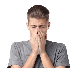 Young man suffering from sinusitis on white background