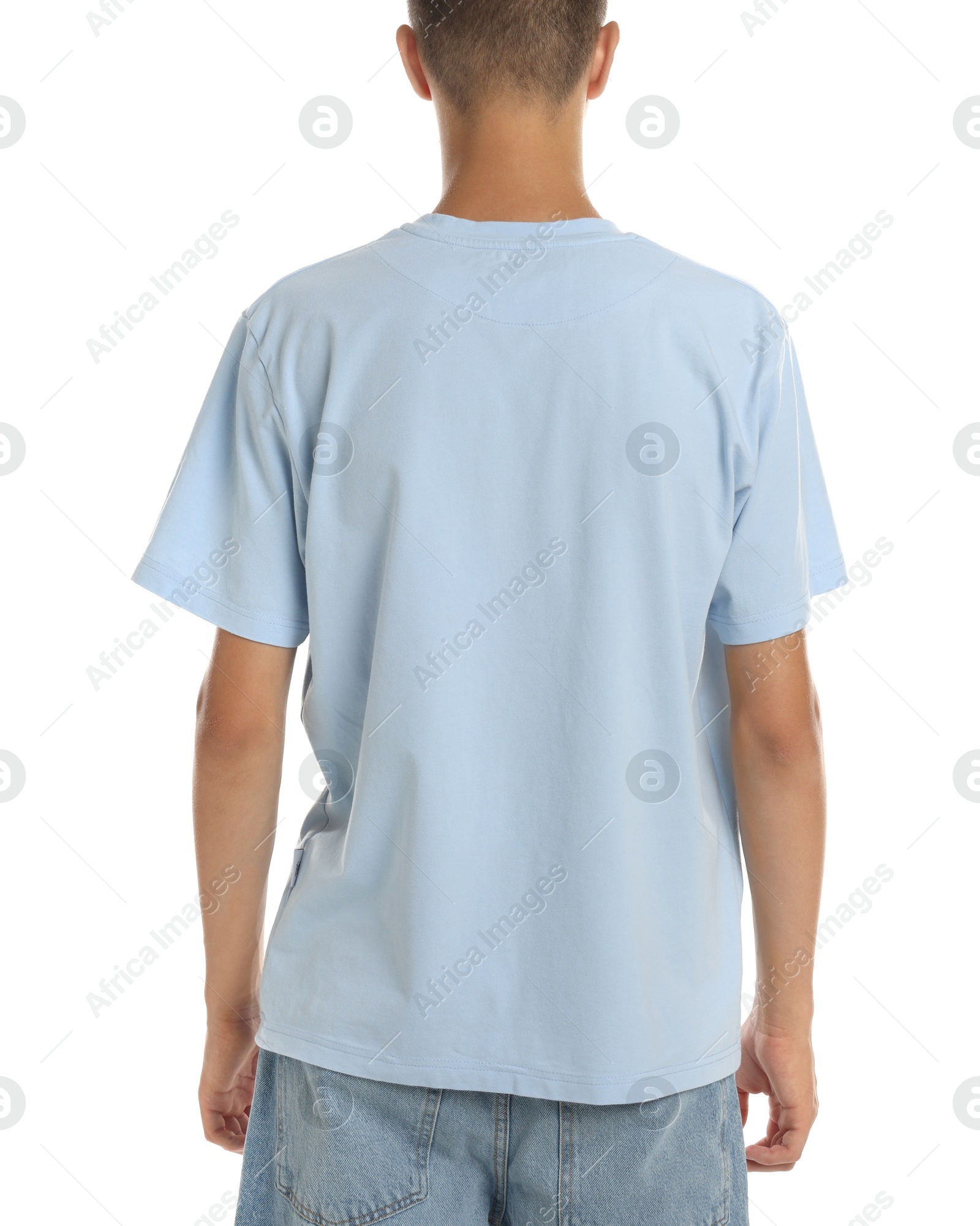 Photo of Teenage boy wearing light blue t-shirt on white background, closeup