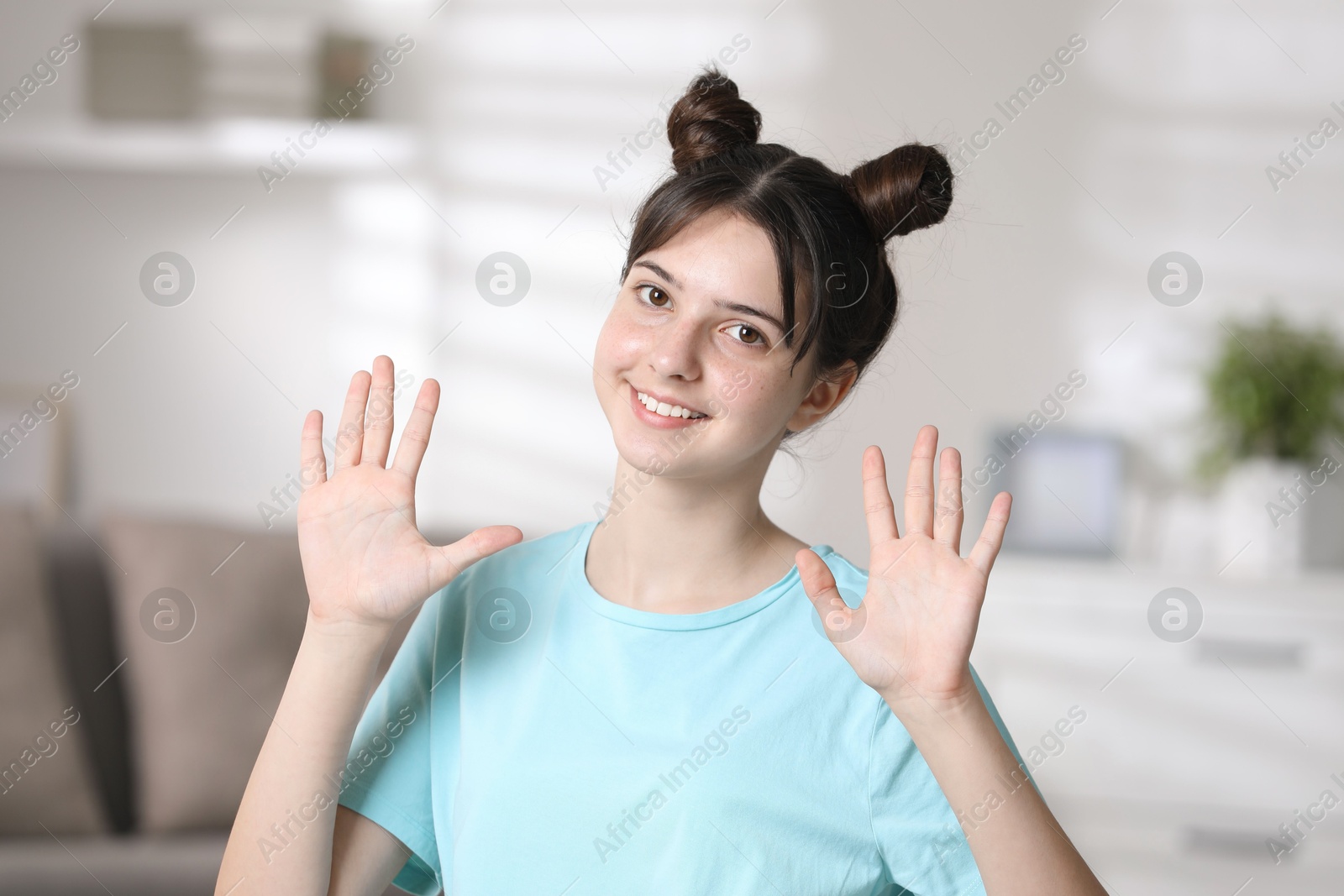 Photo of Portrait of smiling teenage girl at home