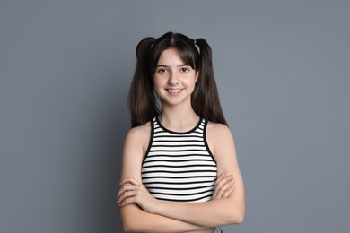 Photo of Portrait of smiling teenage girl on grey background