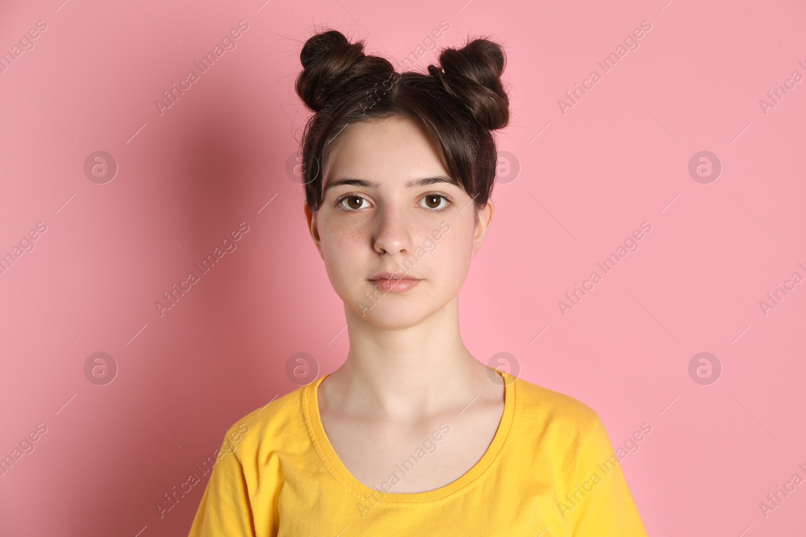 Photo of Portrait of cute teenage girl on pink background