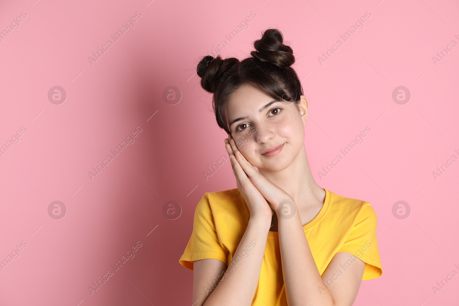 Photo of Portrait of cute teenage girl on pink background. Space for text