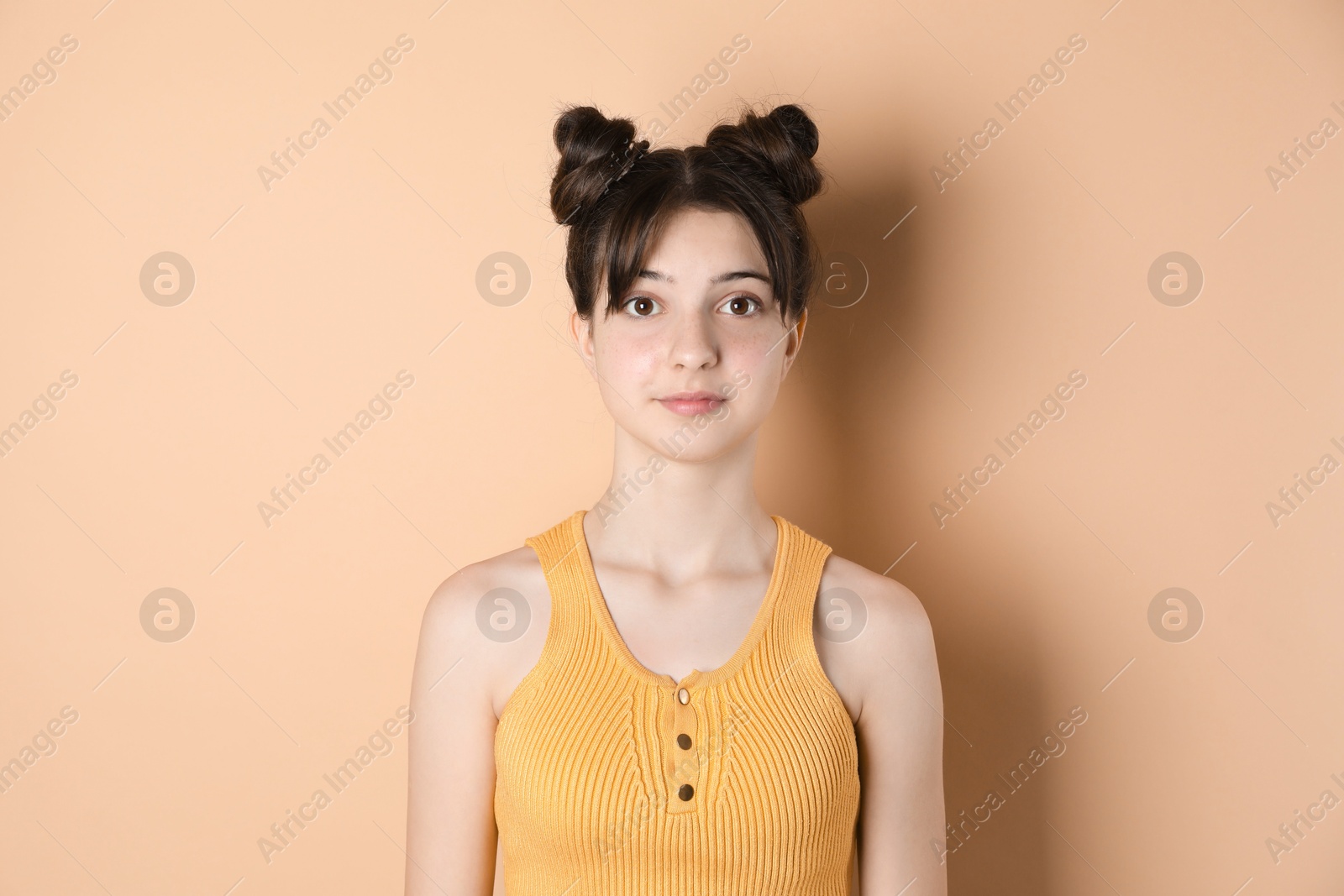 Photo of Portrait of cute teenage girl on beige background