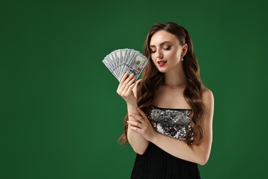 Photo of Charming woman with dollar banknotes on green background. Space for text