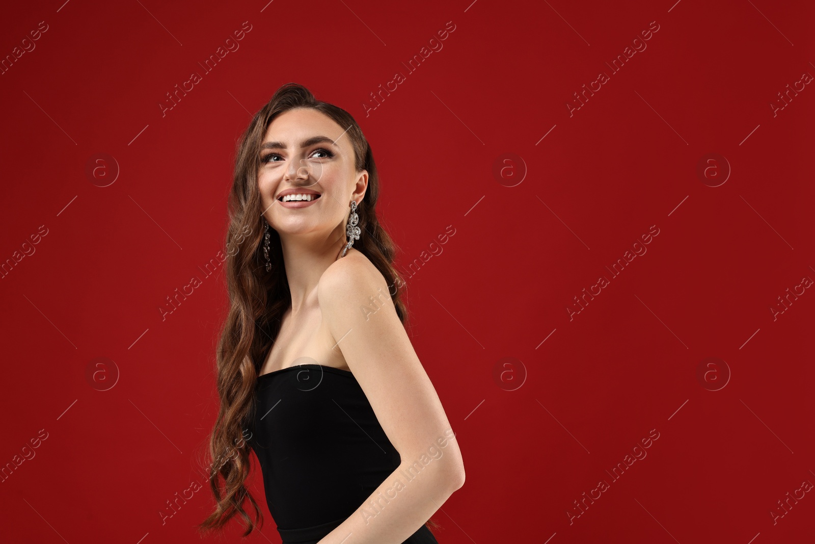 Photo of Portrait of happy woman on red background. Space for text