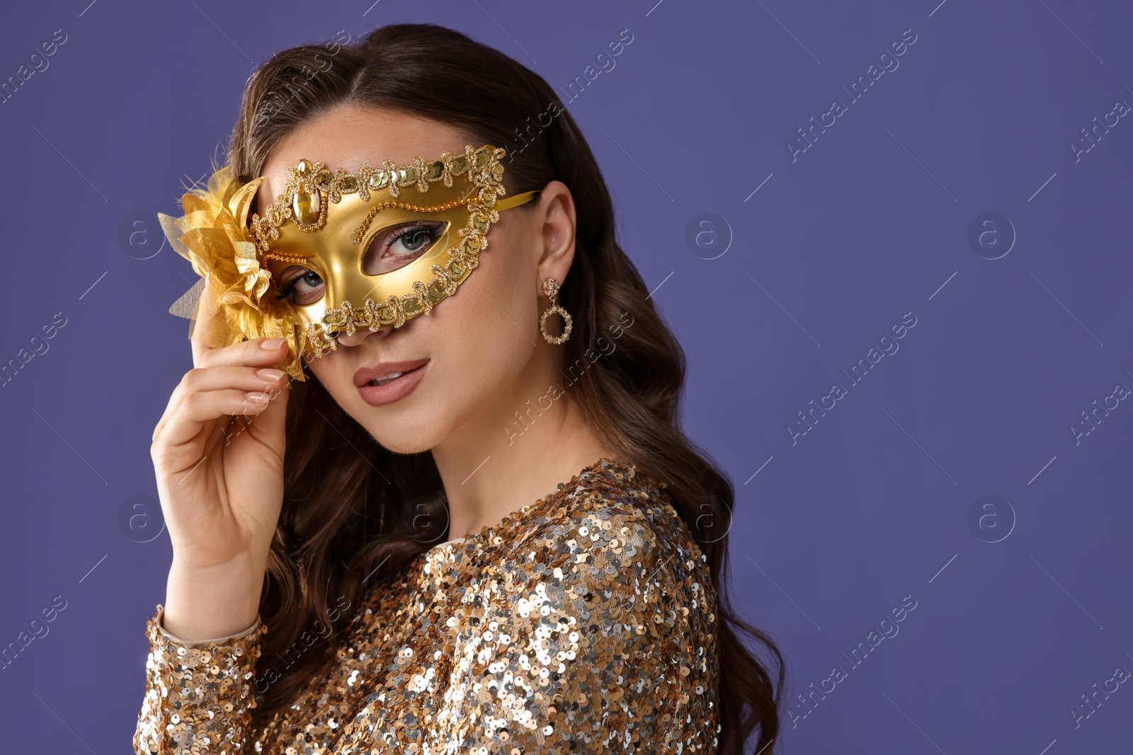 Photo of Beautiful woman wearing carnival mask on purple background. Space for text