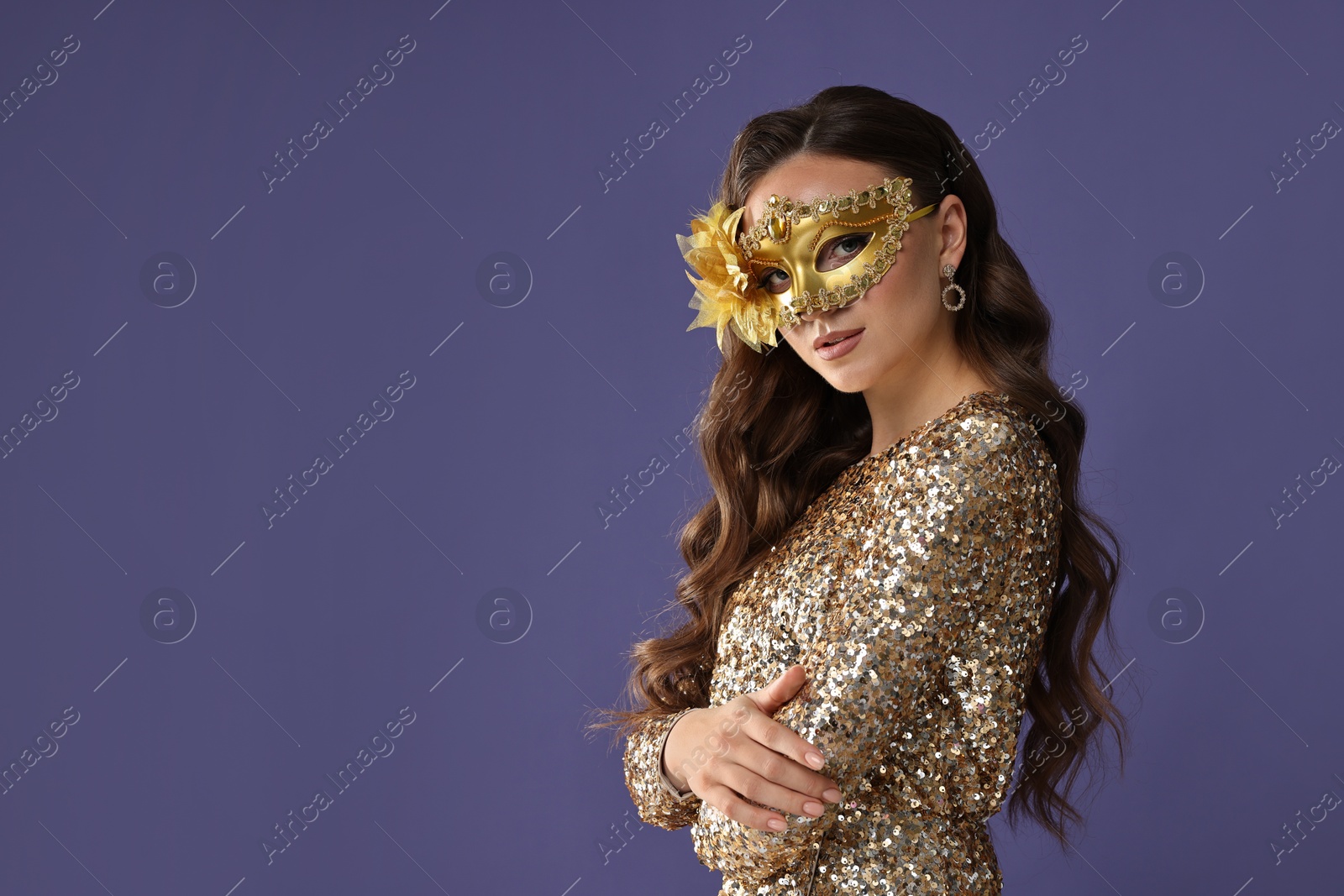 Photo of Beautiful woman wearing carnival mask on purple background. Space for text