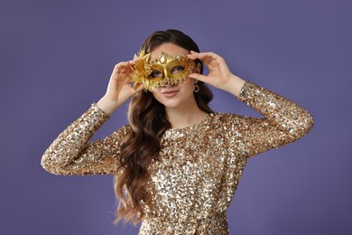 Photo of Beautiful woman wearing carnival mask on purple background