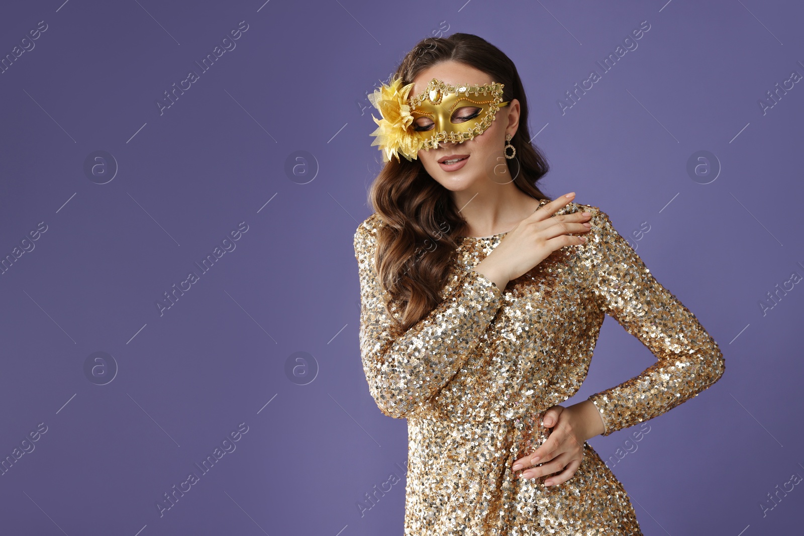 Photo of Beautiful woman wearing carnival mask on purple background. Space for text