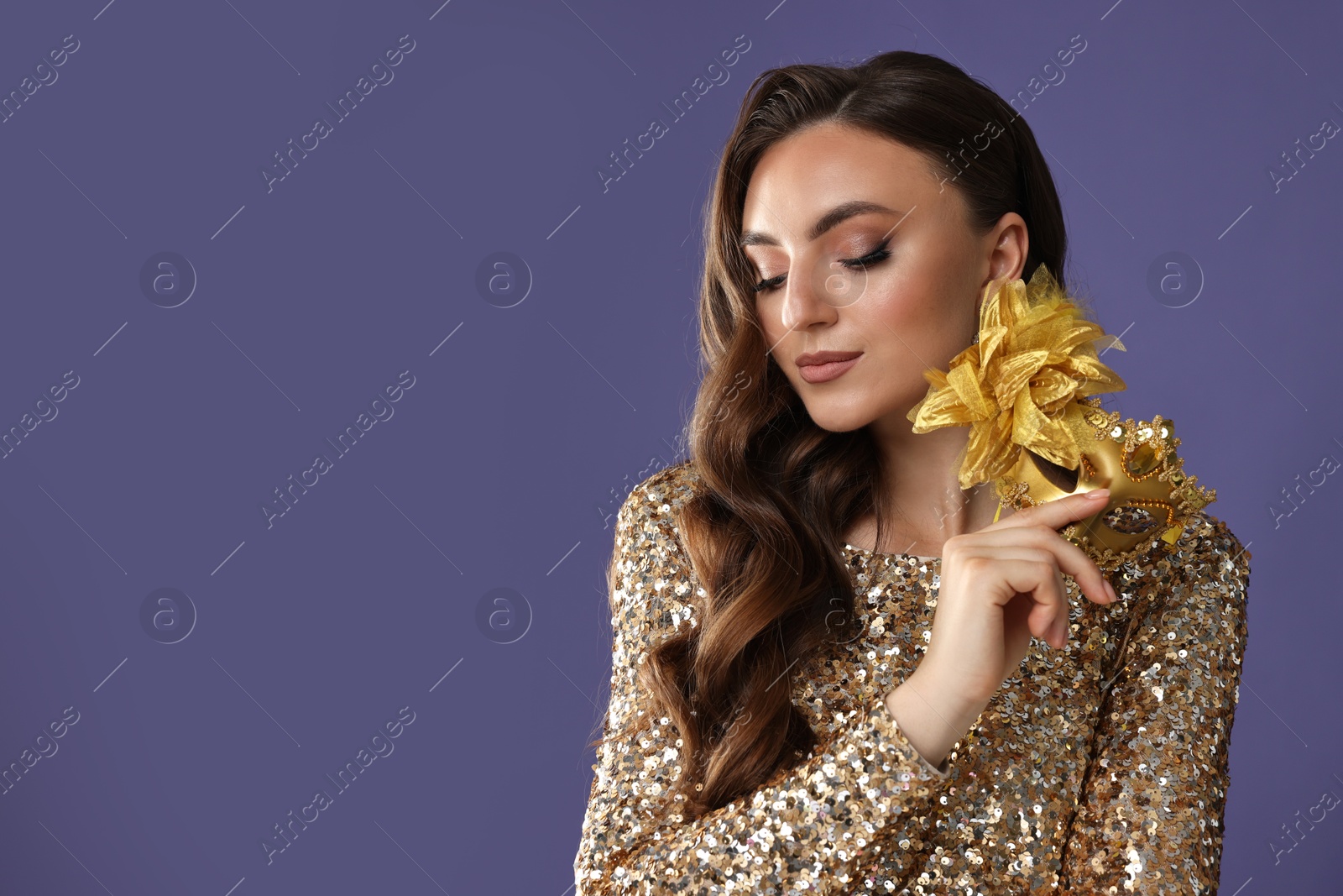 Photo of Beautiful woman with carnival mask on purple background. Space for text