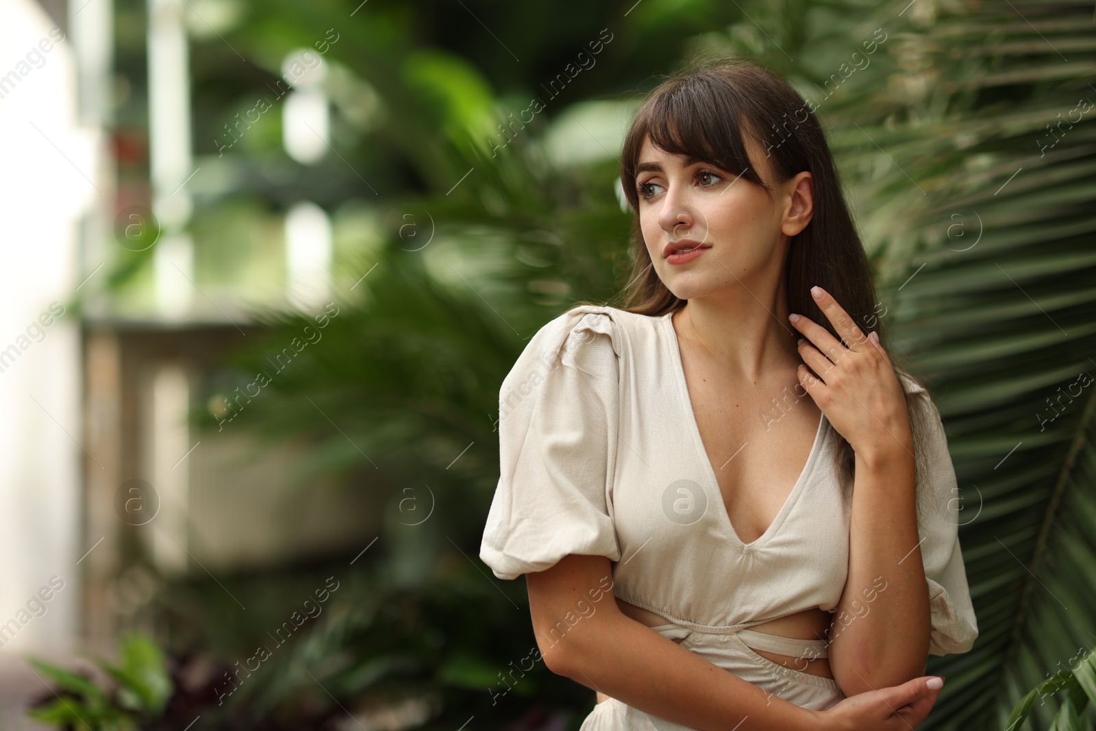 Photo of Portrait of beautiful woman in tropical forest. Space for text