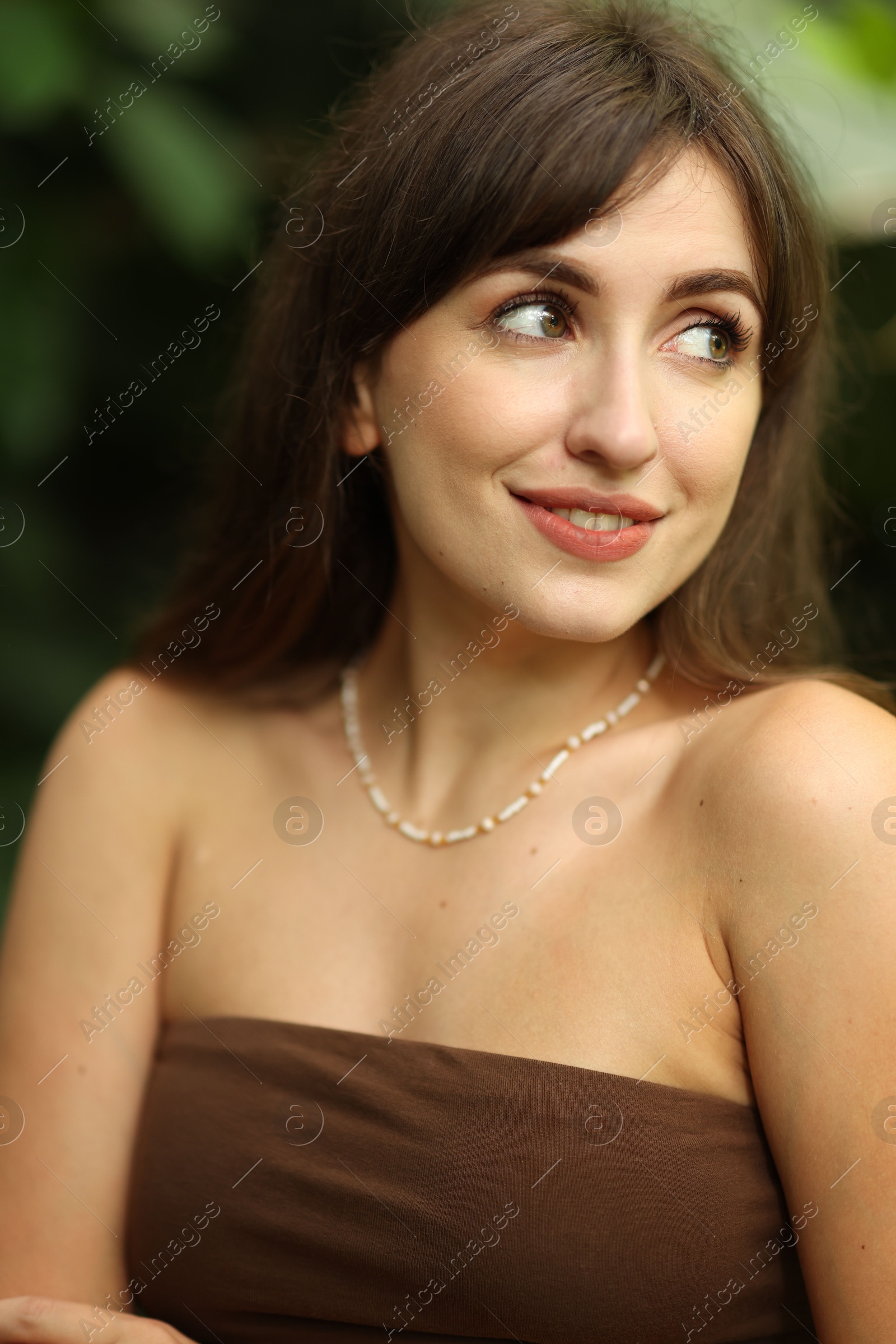 Photo of Portrait of beautiful woman in dress outdoors