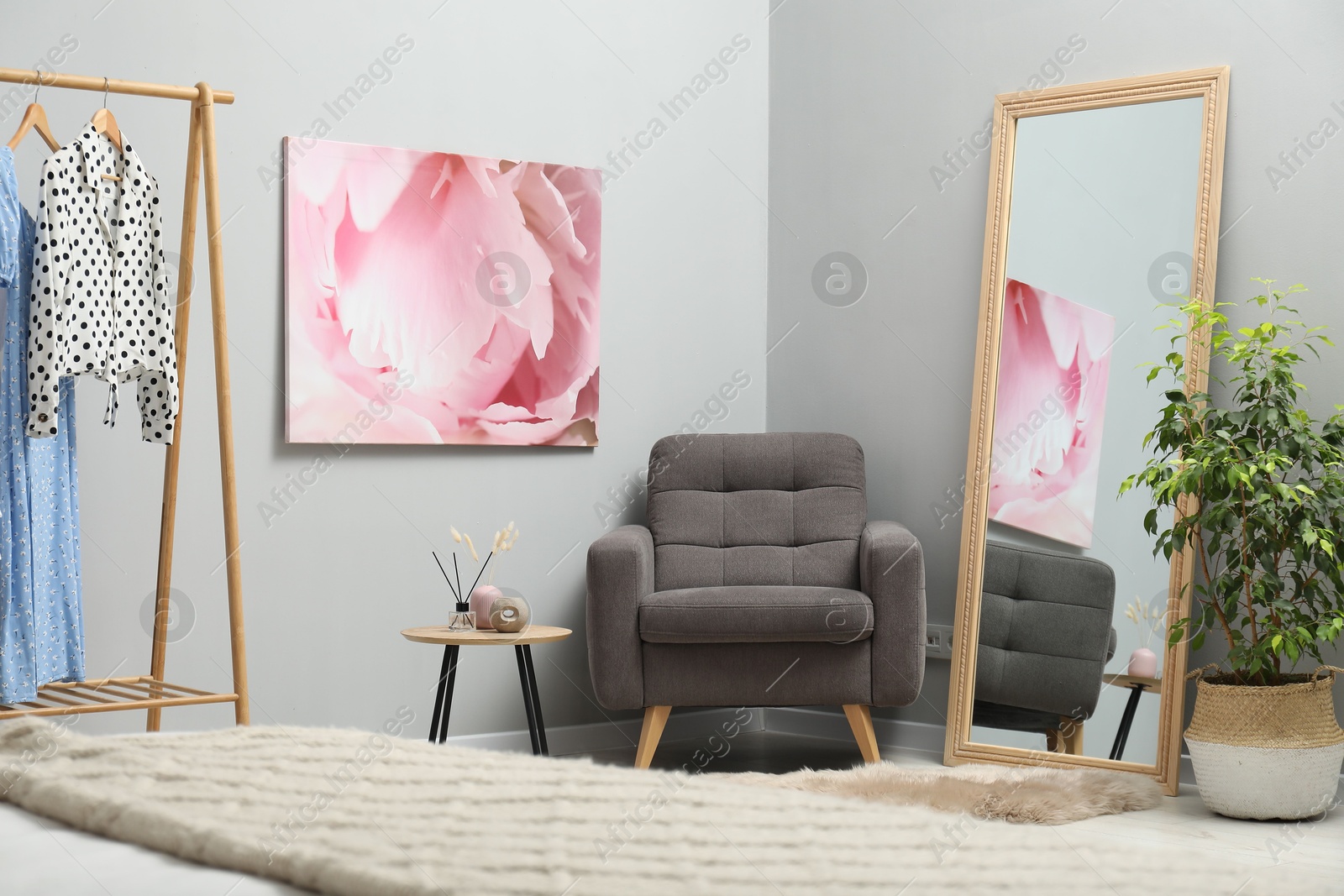 Photo of Large mirror near light gray wall in room. Interior design