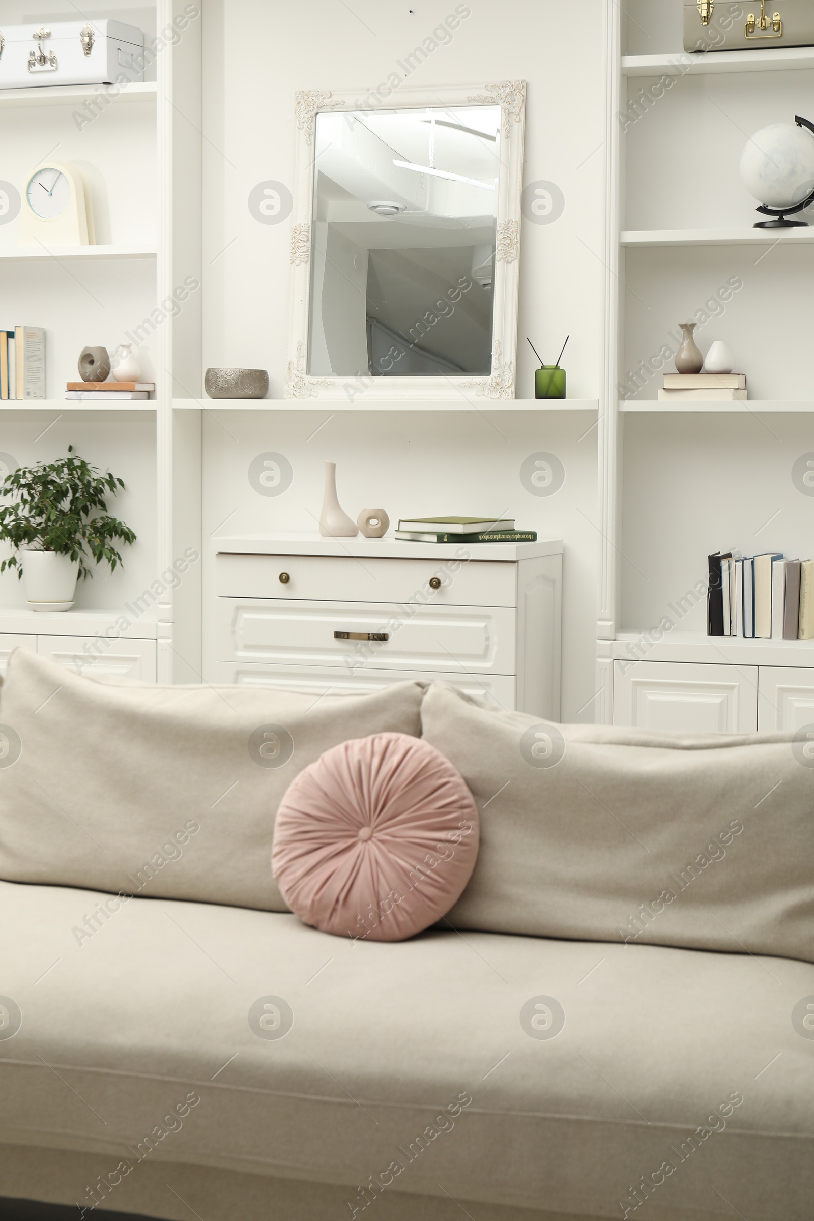 Photo of Mirror on white shelf in room. Interior design