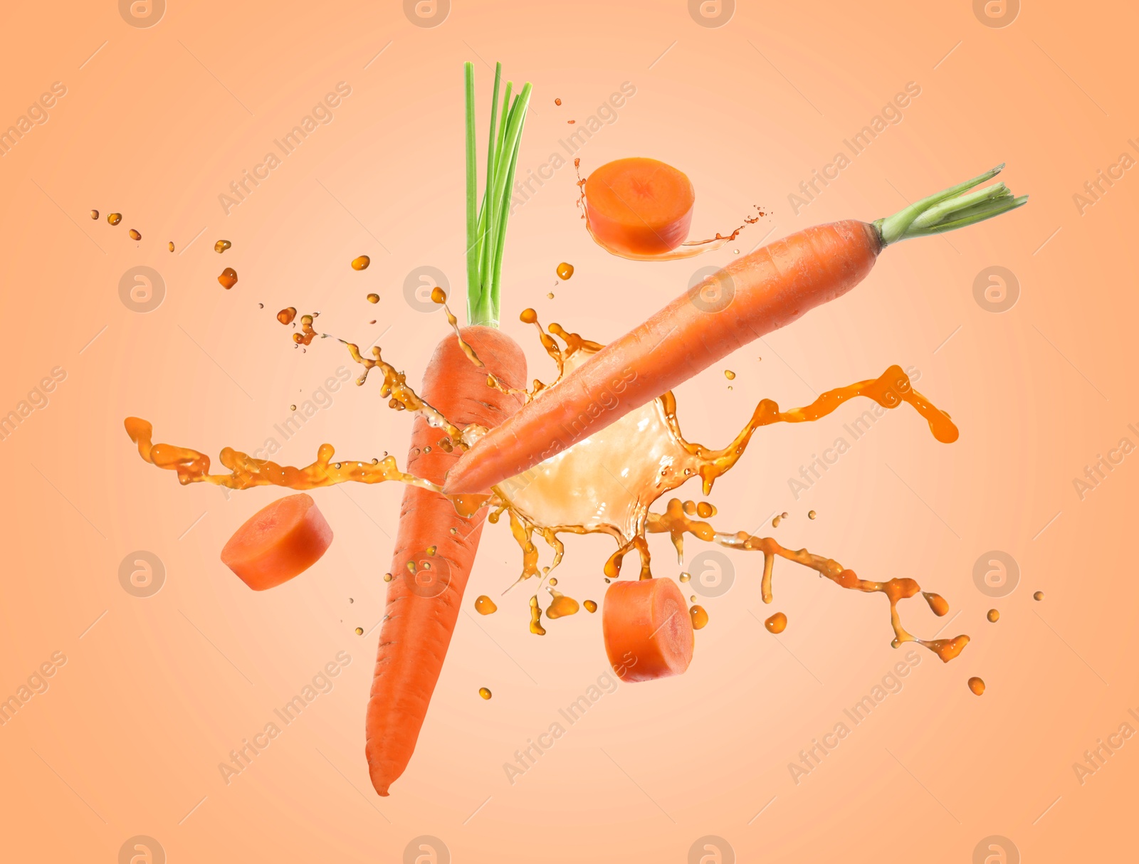 Image of Juice splashes and fresh carrots in air on orange background