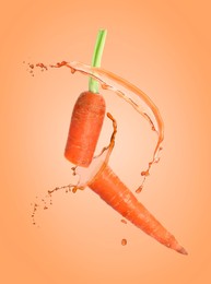 Image of Juice splashes and fresh carrot in air on orange background