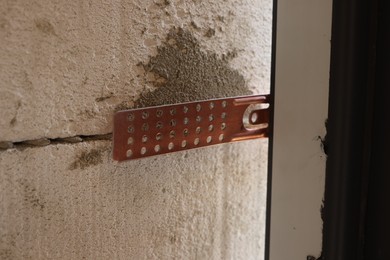 Photo of One copper hinge on newly installed door, closeup