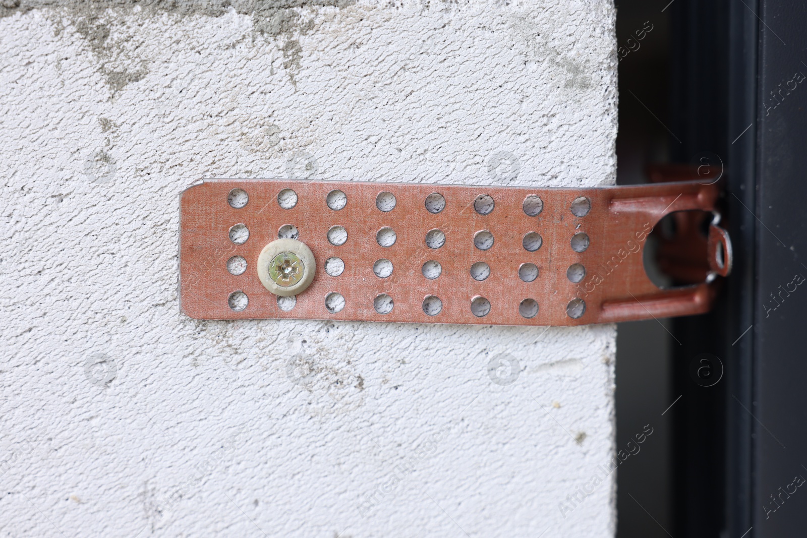 Photo of One copper hinge on newly installed door, closeup