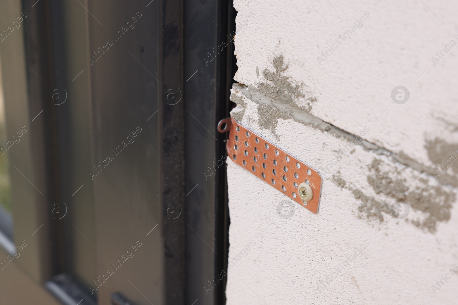 Photo of One copper hinge on newly installed door, closeup