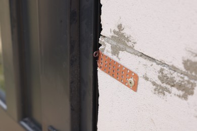 Photo of One copper hinge on newly installed door, closeup