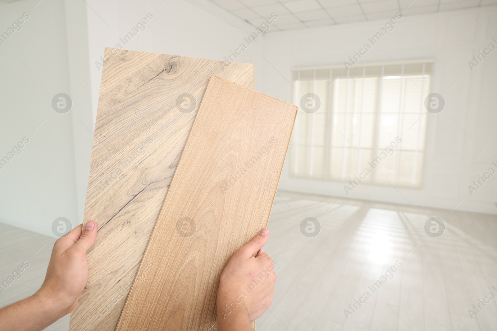 Photo of Man with samples of wooden flooring indoors, closeup. Space for text