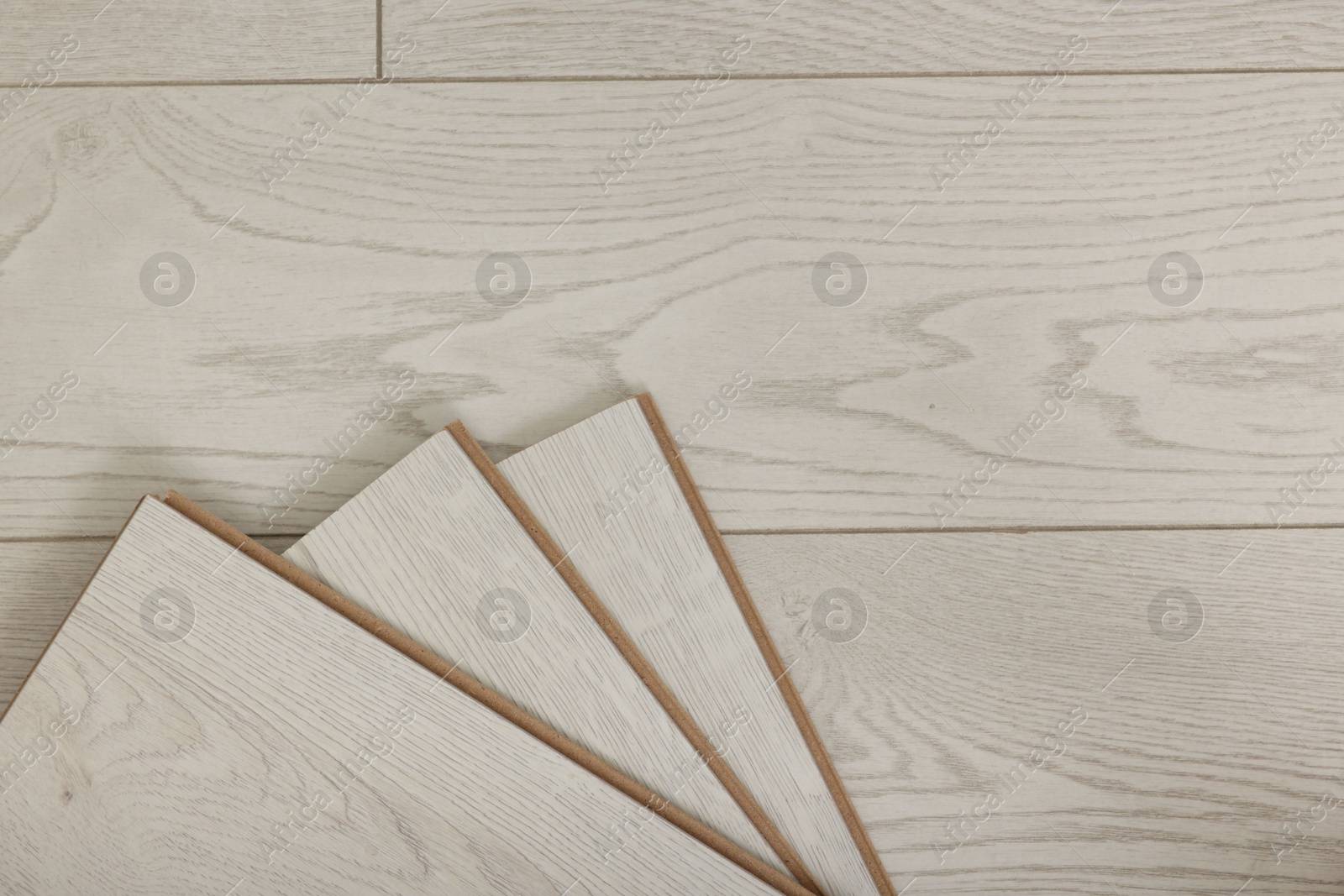 Photo of Samples of wooden flooring indoors, top view. Space for text