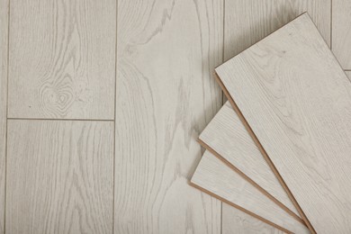 Photo of Samples of wooden flooring indoors, top view. Space for text