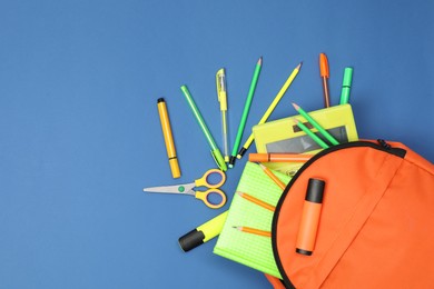 Photo of Backpack and different school supplies on blue background, flat lay. Space for text