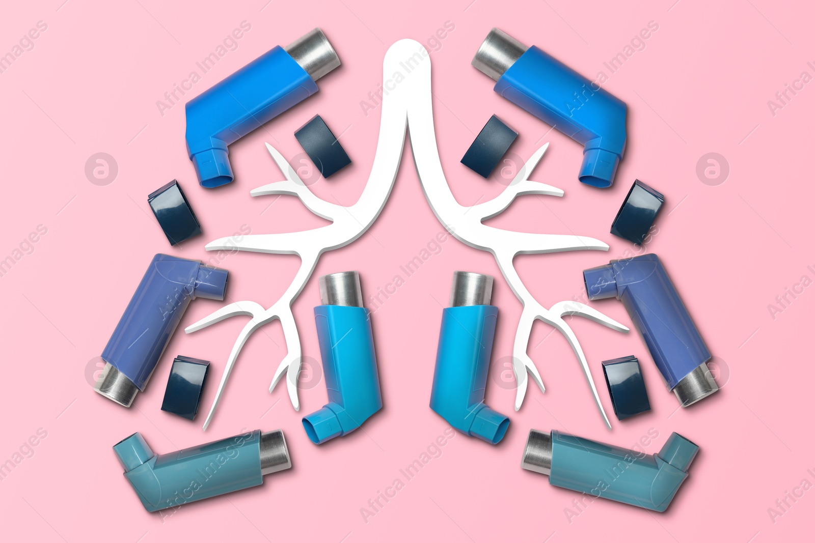 Image of Lungs contour made with asthma inhalers on pink background, top view