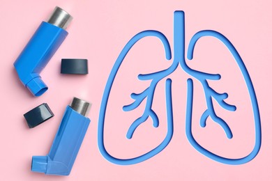 Image of Asthma inhalers and illustration of lungs on pink background, top view