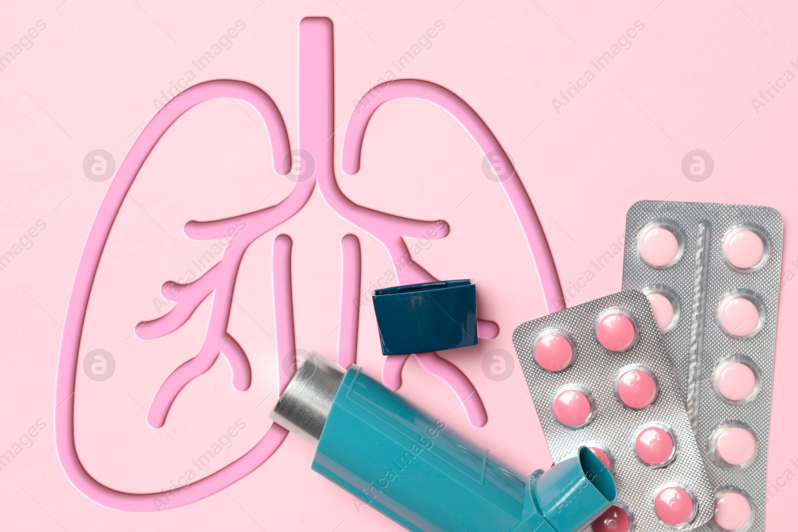 Image of Asthma inhaler, drugs and illustration of lungs on pink background, top view