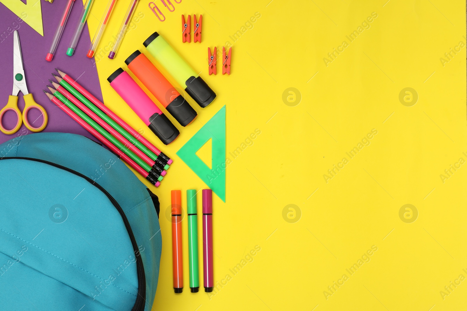 Photo of Flat lay composition with backpack and different school stationery on color background, space for text