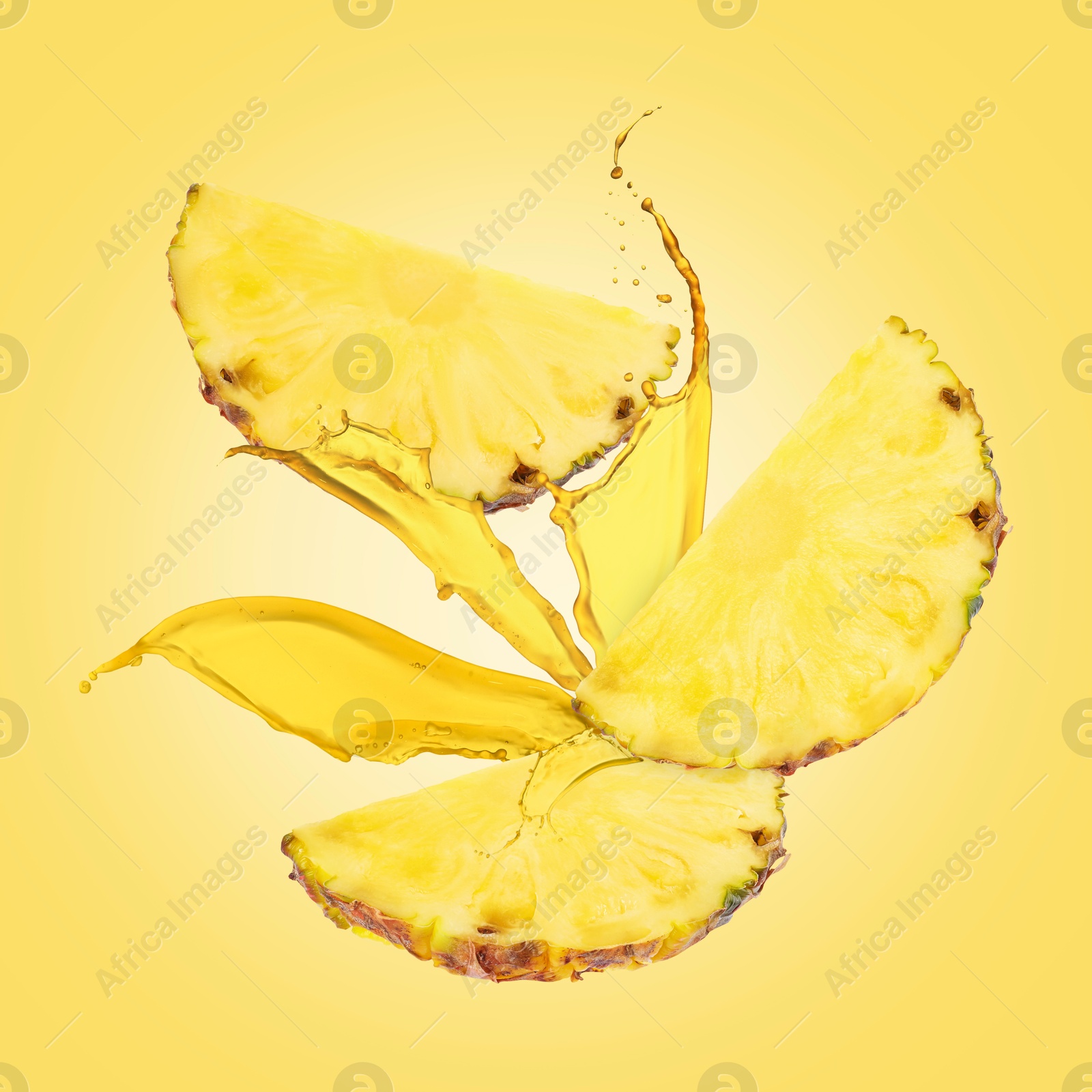 Image of Juice splashes and pineapple slices in air on yellow background