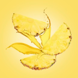 Image of Juice splashes and pineapple slices in air on yellow background