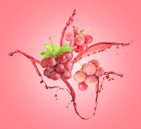 Image of Juice splashes and fresh grapes in air on pink background