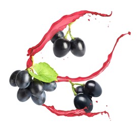 Image of Juice splashes and fresh grapes in air on white background