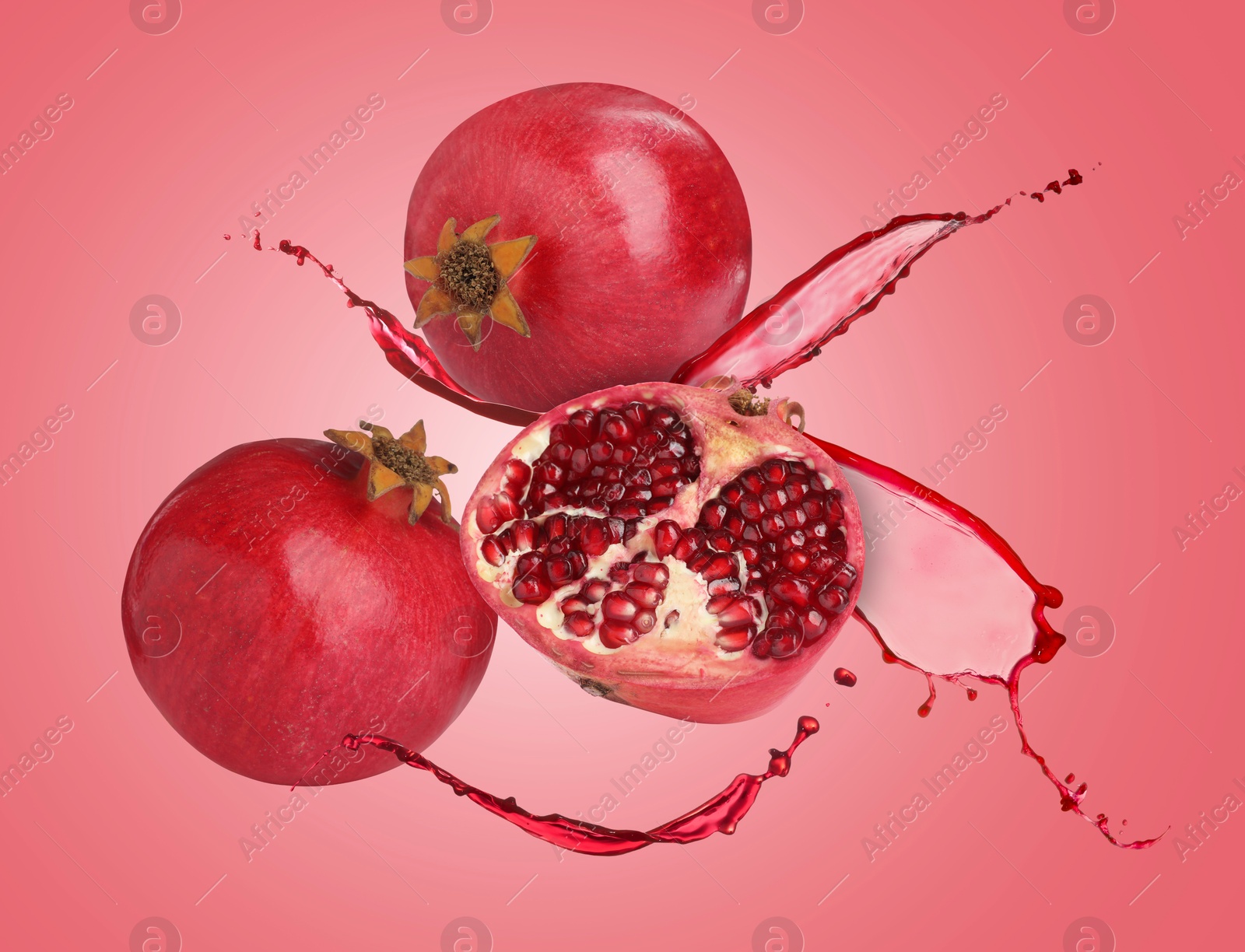 Image of Juice splashes and fresh pomegranates in air on red background