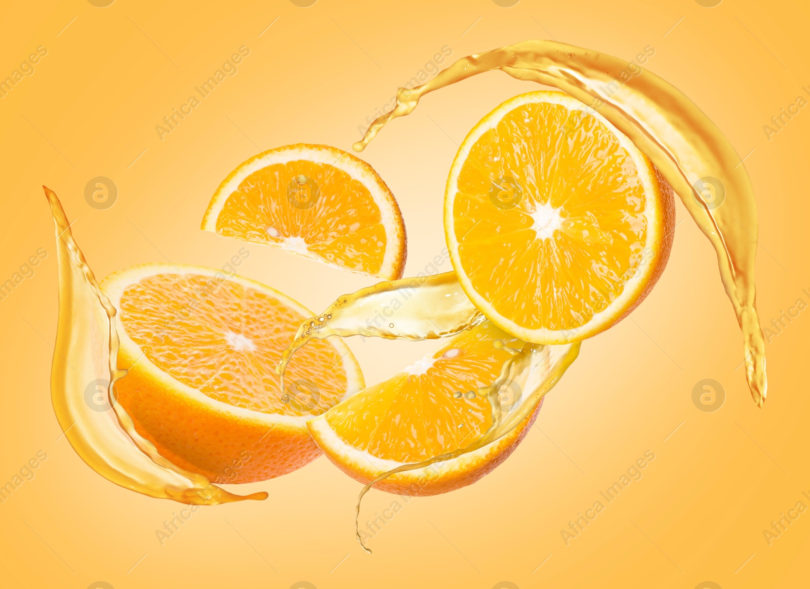 Image of Juice splashes and fresh oranges in air on golden background