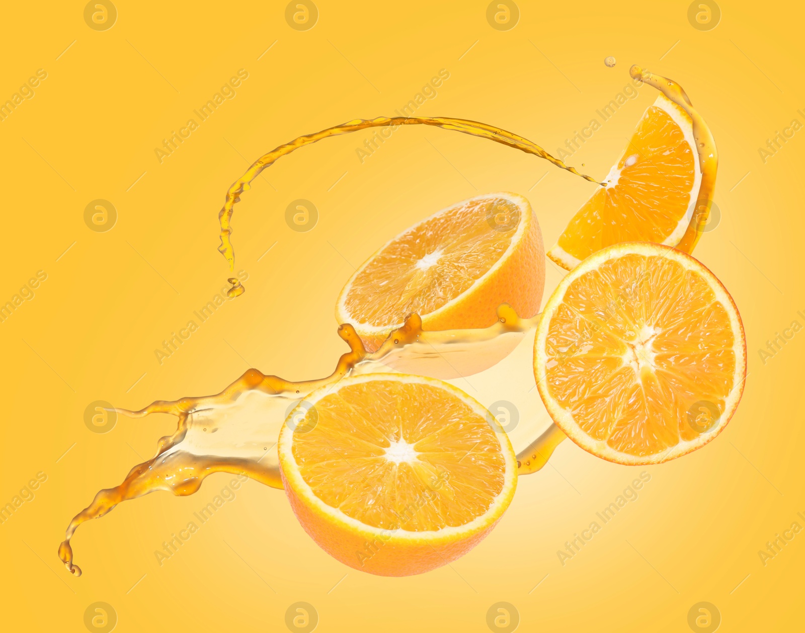 Image of Juice splashes and fresh oranges in air on golden background