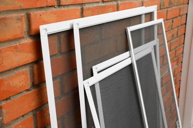 Photo of Set of window screens near brick wall