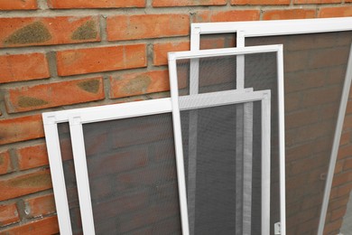 Photo of Set of window screens near brick wall