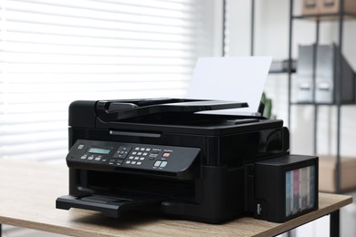 Photo of Modern printer with paper on table in office