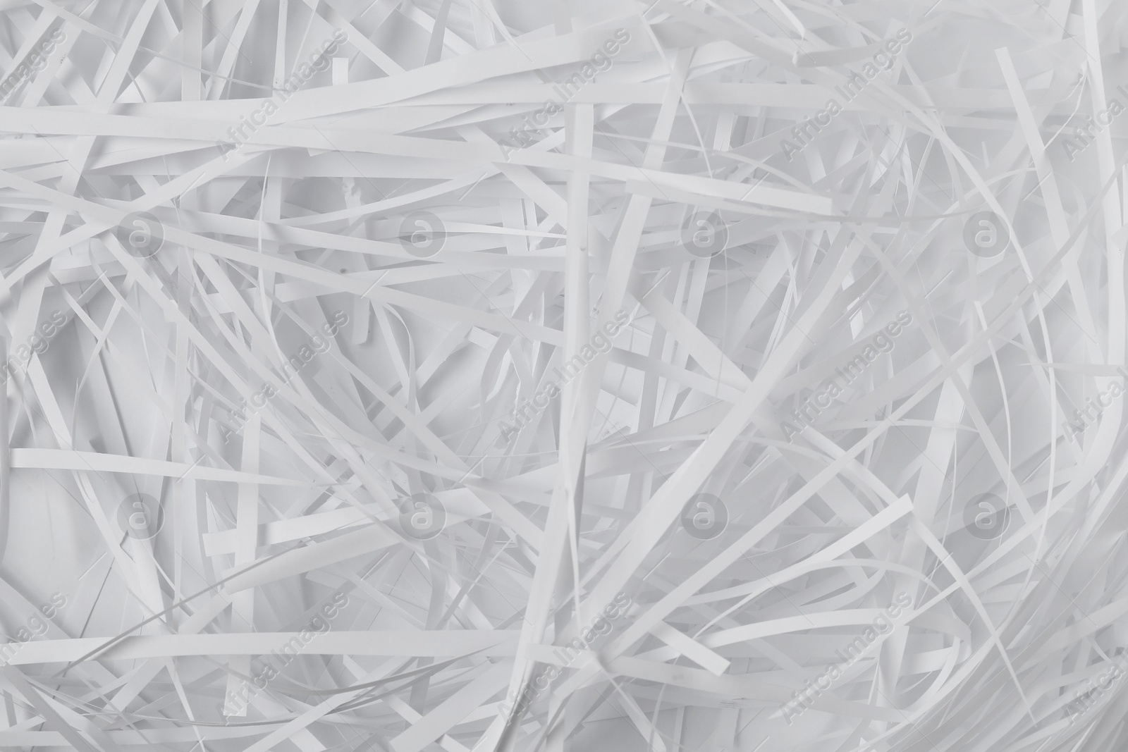 Photo of Pile of shredded paper on white background, top view