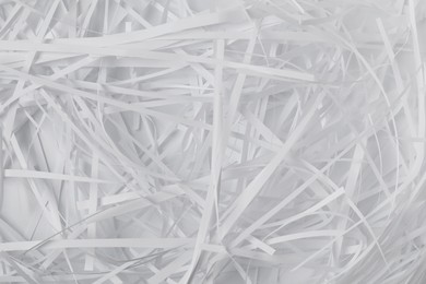 Pile of shredded paper on white background, top view