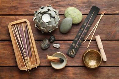 Photo of Flat lay composition with incense sticks on wooden table. Om ligature