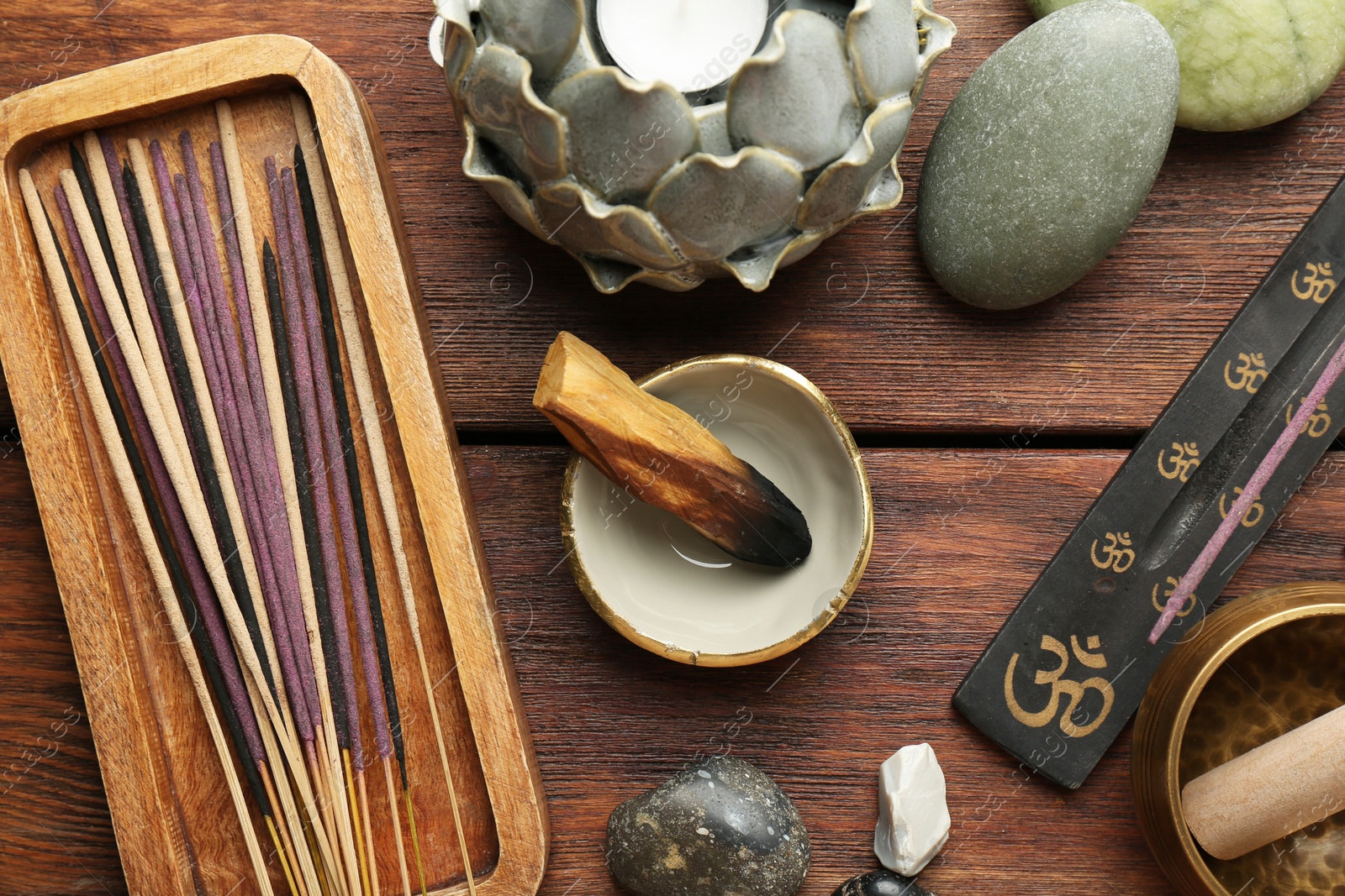 Photo of Flat lay composition with incense sticks on wooden table. Om ligature